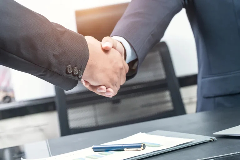 business-people-shaking-hands-446565871.jpg